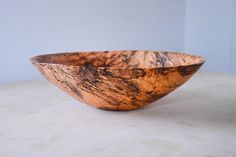 a wooden bowl sitting on top of a table