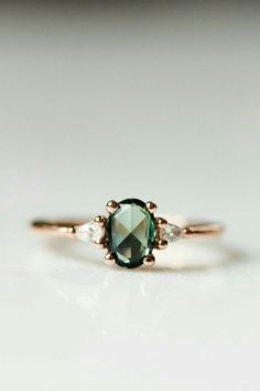 a green and white diamond engagement ring