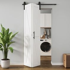 an open door to a washer and dryer in a room with wood floors