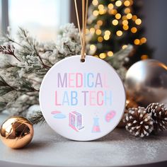 a medical lab tech ornament hanging on a table next to some christmas decorations