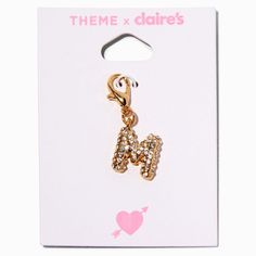 a gold colored charm with the letter h on it's front and back side