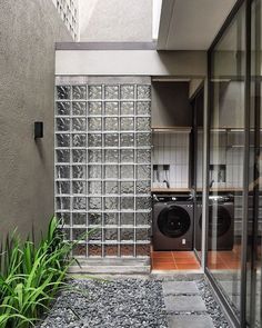 a washer and dryer sitting in the middle of a room next to a window