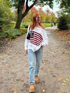 STYLE INFORMATION: Show your patriotic pride in the Land of Free White Oversized Flag Sweater! White knit fabric forms a boat neck sweater that can be worn or slouchy off-the-shoulder. Oversized bodice with drop shoulders and long sleeves. Features alternate knit with American flag design. Style over your favorite jeans for a cute casual look! DETAILS & CARE: 100% Cotton Hand wash cold. Imported. SHIPPING: Orders are processed within 1-2 business days. Packages are shipped out Monday-Friday, hol American Sweater, White Oversized Sweater, Flag Sweater, Nyc Fits, Usa Sweater, Boat Neck Sweater, American Flag Sweater, American Flag Design, Chill Outfits