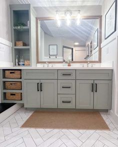 a bathroom with gray cabinets and white tile flooring