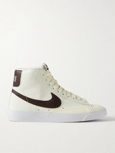 Nike's 'Blazer Mid '77' high-top sneakers date back nearly five decades, and clearly have lasting appeal, as they're still so cool today. This pair is made from crinkled-nubuck in a brown and cream colorway and has suede trimming the toes. The padded collar ensures a comfortable fit. Nike Blazer Mid 77 Brown, Brown Nike Blazers, Nike Blazer Mid 77 Colors, Twin Outfit, Custom Nike Blazers, Blazer Mid 77 Vintage, Nike High Tops, Nike High, Nike Blazer Mid 77