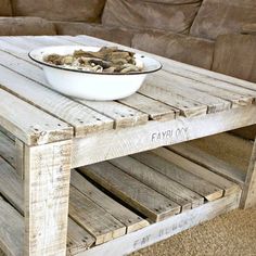 a table made out of pallets with a bowl of mushrooms sitting on top of it