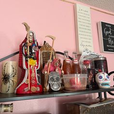 a shelf filled with lots of bottles and figurines next to a sign on the wall