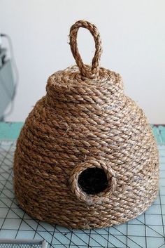 a woven basket with a hole in the middle on a table next to a pair of scissors