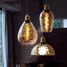 three light bulbs hanging from a ceiling in a room