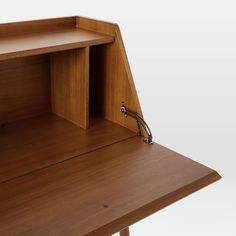 a wooden desk with an open shelf on top