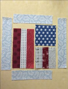 an american flag made out of strips of fabric on a piece of paper with scissors next to it