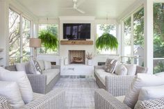 a living room filled with furniture and a flat screen tv mounted on the wall over a fire place