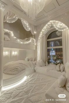 a bedroom decorated in white with lots of lights on the ceiling and windows above it