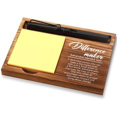 a note pad with a pen on it and a sticky pad attached to the board