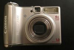 a silver camera sitting on top of a table