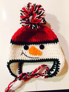 a crocheted hat with a snowman face on it