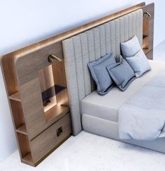 a bed that has pillows on it and a book shelf in the corner next to it