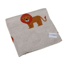 an orange and white lion print on a linen pocket with a tag hanging from it