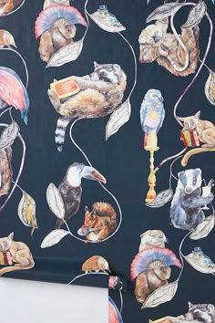 a black wallpaper with birds and other animals on it's back side,