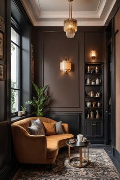 Elegant sitting area with a brown sofa, decorative wall lights, and a small table with tea set in a cozy, dimly lit room. Dark Academia Living Room, Art Deco Living, Dark Wood Table, Deco Living Room, Art Deco Living Room, Stunning Interior Design, Modern Houses Interior, Decor Buy, Khalid