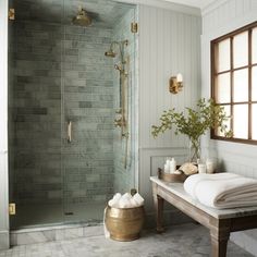 a bathroom with a walk in shower next to a sink