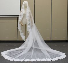 a white veil on a mannequin in a room