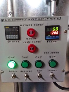 the control panel for an automatic water heater is shown with green buttons and red knobs