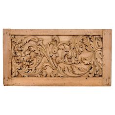 carved wood panel with floral design on white background