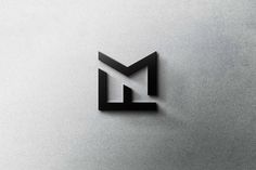 the letter m is made up of black and white letters on a gray background,