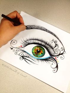 someone is drawing an eye with colored pencils