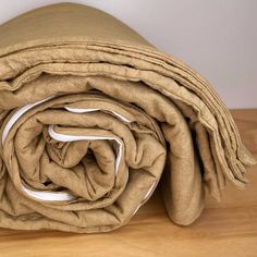 a blanket folded on top of a wooden table