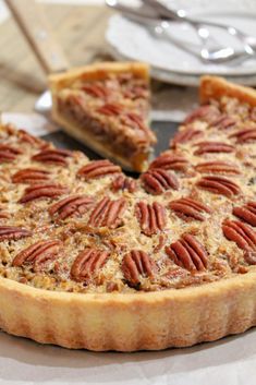 a pecan pie on a plate with one slice cut out and ready to be eaten