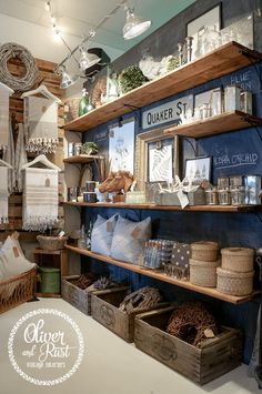 a store with shelves filled with items and pictures on the wall above them, along with baskets