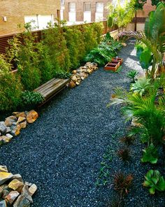 an outdoor garden with gravel, rocks and plants