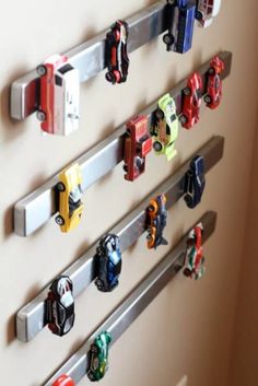 there are many toy cars hanging on the wall