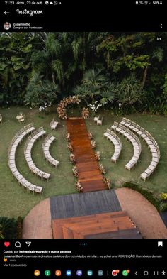 an aerial view of a wedding venue with white chairs and wooden steps leading up to the aisle