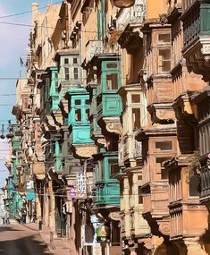 a street lined with tall buildings and balconies