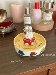 a hello kitty figurine sitting on top of a counter next to other items