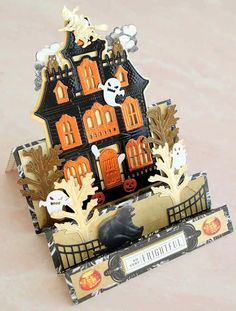 a halloween card with a house made out of paper