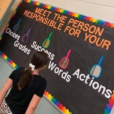 a girl standing in front of a sign that says meet the person responsible for your choices