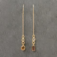 "These 18k Gold, Diamond, and Tourmaline Drop Chain Earrings are a one-of-a-kind, ethical addition to any jewelry collection.  Upcycled from vintage fine gold chains, these earrings feature 14k fishhooks at the top and channel set diamonds in 18k gold along the chain. The deep red and orange tourmaline gems, also set in 18k gold, add a pop of color to the earrings and hang elegantly as a drop. These earrings are the perfect combination of elegance and uniqueness, and can be worn with any outfit Luxury Gemstone Linear Earrings In Fine Jewelry Style, Beaded Jewelry Earrings, Red Tourmaline, Diamond Evil Eye, Tourmaline Earrings, Red And Orange, Jewelry Lookbook, Hanging Earrings, Diamond Drops