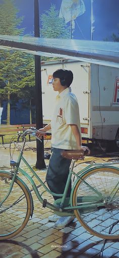 a man standing next to a green bike