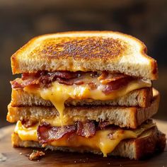 a grilled cheese and bacon sandwich on a cutting board