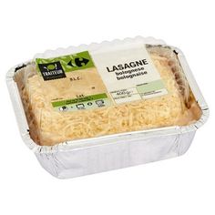 an image of lasagne in foil container on white background