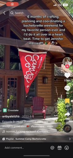 a red flag hanging from the side of a wooden building with words written on it