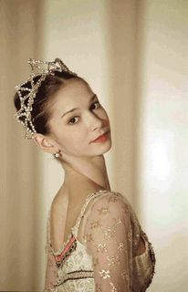 a woman wearing a tiara and posing for the camera