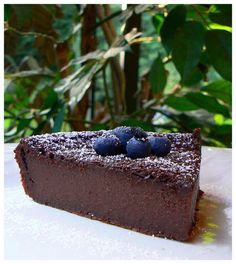 a piece of chocolate cake with blueberries on top