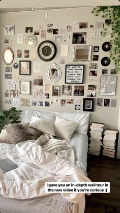 a bed with lots of pictures on the wall above it