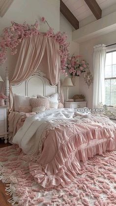 a bedroom with pink flowers on the ceiling and bed in the center, along with white furniture