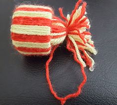 a red, white and blue ball of yarn on top of a black tablecloth